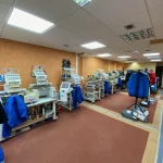 An embroidery demo room showing several SWF machine and garments