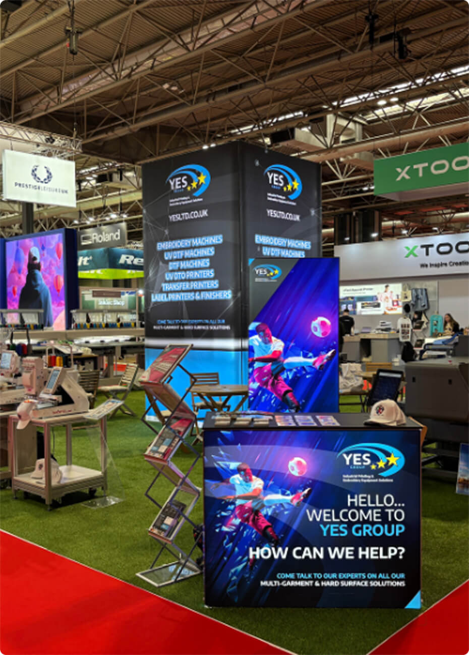 YES Group stand at Printwear and Promotion LIVE 2026 showing embroidery, DTF and UV printing equipment